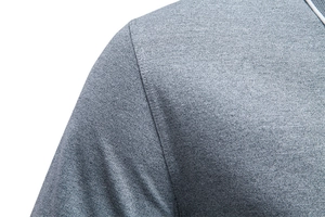 Detail of grey polo shirt shoulder with breathable mesh texture and white trim