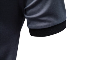Detail of grey piqué polo shirt sleeve with ribbed black cuff and neat stitching