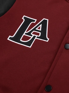 Macro shot of burgundy varsity jacket with LA patch and black metal snap buttons