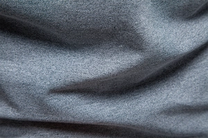Close-up of greyish blue knitted polo fabric showing breathable cross-weave texture detail