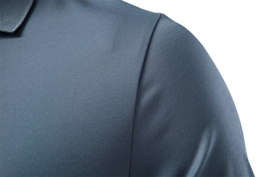 Detailed close-up of dark blue breathable mesh fabric and shoulder seam on a men's polo shirt