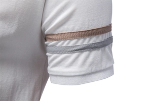 Close-up of white polo shirt cuff featuring brown and grey herringbone woven stripes