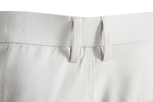 Detailed close-up of men's beige trousers featuring belt loops and fine twill fabric texture