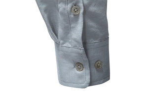 Macro detail of men's silver-grey long sleeve shirt cuff with matching four-hole buttons