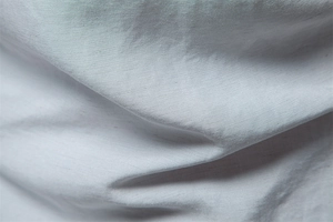 Macro view of light grey textured fabric showing breathable weave detail for men's shirt
