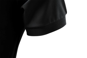 Detailed macro view of black polo shirt featuring textured knit mesh and ribbed cuffs