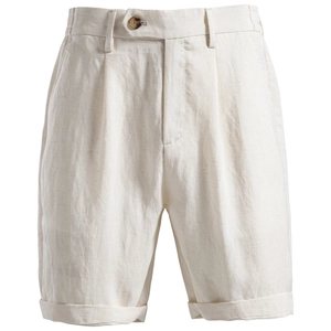 Detailed macro view of beige Lyocell cotton shorts featuring pleated waist and cuffed hem
