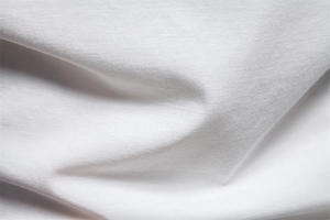 Detailed close-up of white breathable Tencel knit fabric with soft textured folds