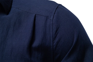 Macro shot of reinforced double stitching and textured navy cotton-linen shirt fabric