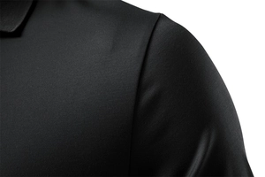 Macro shot of black polo shirt showing breathable pique knit texture and shoulder seam detail