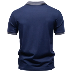 Back view of men's navy jacquard polo shirt with grey tipped collar and cuffs