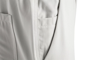 Macro detail of men's grey casual trousers showing side pockets and reinforced double stitching
