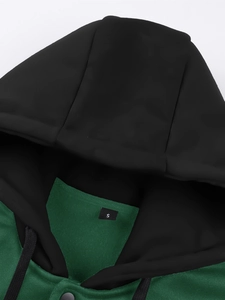 Detail of knitted hoodie neckline showing size S label, flat drawstring and metal button