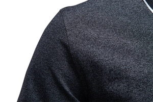 Close-up of the dark gray knitted polo shirt with contrasting white piping on the collar