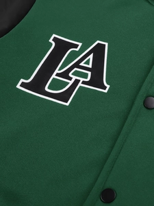 Close-up of printed LA logo on dark green knit baseball jacket with matte snap buttons