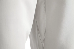Detailed macro view of the double reinforced stitching on white and grey trousers