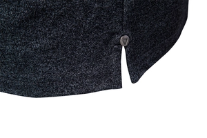 Detailed close-up of side slit on dark grey polo shirt with metal rivet reinforcement