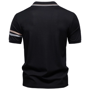 Back view of black tencel polo shirt with beige striped collar and pique texture