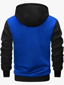 Back view of a color-block hooded jacket featuring blue knit body and black ribbed sleeves