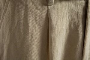 Detail view of khaki cotton-lyocell shorts showing belt loops and fine stitching