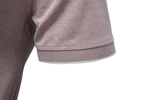 Detailed macro view of the ribbed cuff with white stripe on a tan pique polo shirt