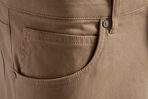 Close-up of khaki cotton chino pants featuring a coin pocket and copper rivet detail