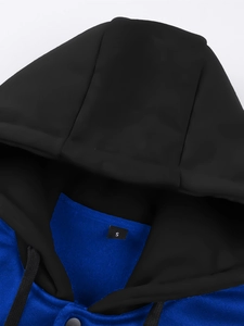 Detail shot of black and royal blue hoodie collar featuring stitched size S label