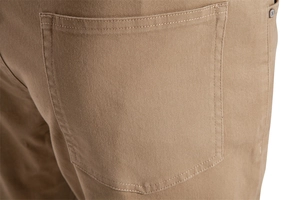 Close-up of khaki cotton twill pants featuring a rear pocket with metal rivet and stitching