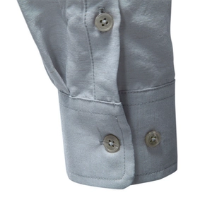 Close-up of a grey long-sleeved business shirt cuff with premium textured fabric
