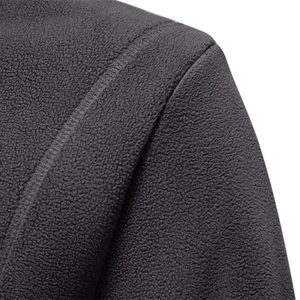 Close-up of deep gray men's polar fleece hoodie showing warm textured fabric and stitching