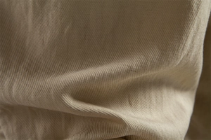 Macro shot of high-quality khaki Lyocell cotton fabric texture and soft weave detail