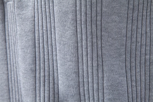 Vue macro détaillée de la texture du tissu en maille côtelée grise d'un polo homme