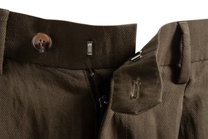 Detail view of lyocell shorts featuring amber textured button and fine twill fabric texture