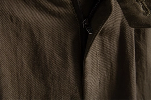 Macro shot showing detail of the zipper and high-density twill fabric of men's shorts