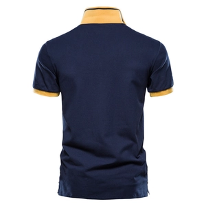 Men's navy polo shirt with yellow collar trim and breathable cotton fabric in flat lay view