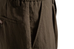 Detail view of Lyocell cotton shorts showing twill texture and pleated waist design