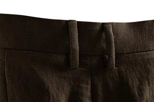 Detailed close-up of dark brown business casual shorts showing waistline and belt loops