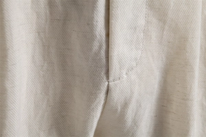 Macro shot of lyocell cotton shorts showing premium stitching and twill fabric texture