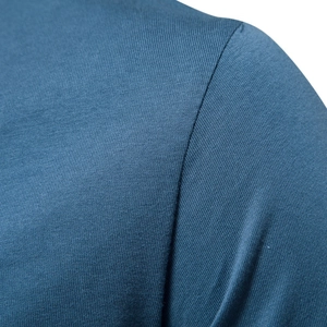 Detailed texture of blue knit cotton V-neck T-shirt showing premium stitching quality