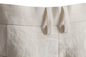 Detailed close-up of beige twill fabric and belt loops on men casual shorts