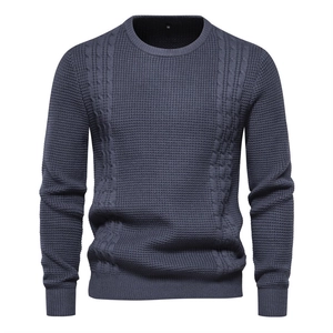 Men's dark blue waffle knit sweater featuring cable knit patterns and classic crew neck
