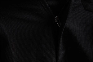 Detail of high-quality metal zipper and twill fabric texture on black business shorts
