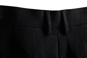 Close-up detail of belt loops and twill fabric texture on black business casual shorts