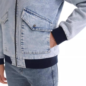 Men's light blue washed denim bomber jacket with navy ribbed cuffs and front metal zipper