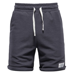 Men's dark grey waffle knit athletic shorts with elastic drawstring waist and logo patch