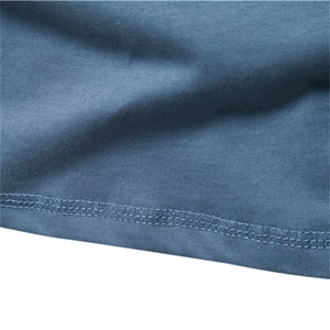Close-up of blue cotton long sleeve t-shirt hem with reinforced double-needle stitching