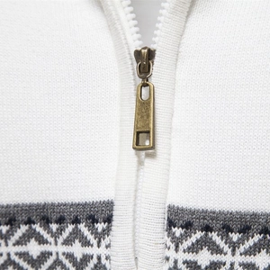 White knit sweater with half-zip collar and grey geometric patterns on the hemline