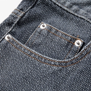 Close-up of star pattern denim shorts with herringbone texture and rivet details
