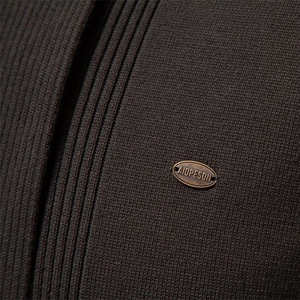 Dark brown men's knit cardigan featuring ribbed texture and a bronze metal logo badge