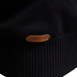 Men's premium black knit sweater with half-zip collar and luxury leather logo detail